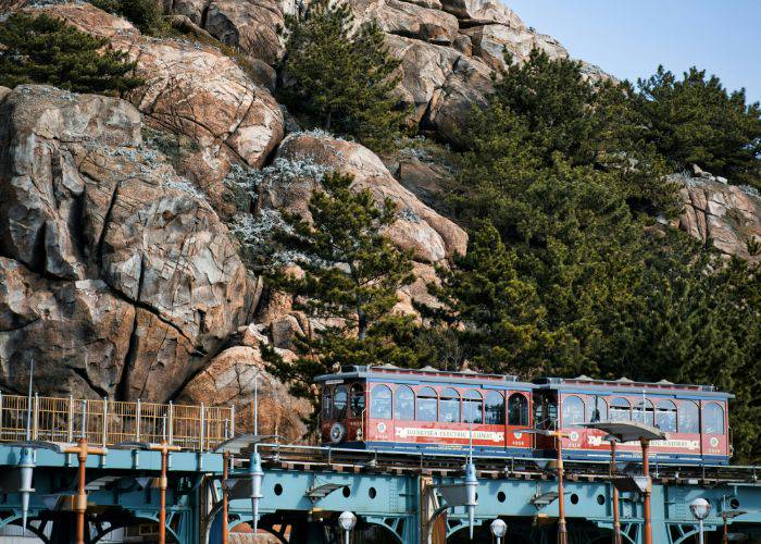 The Tokyo DisneySea monorail, dwarfed by a fake mountain decoration in the background.